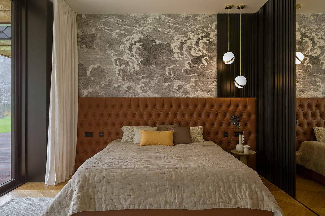 Luxurious bedroom with tufted leather headboard, statement lighting, and striking cloud-patterned wallpaper.