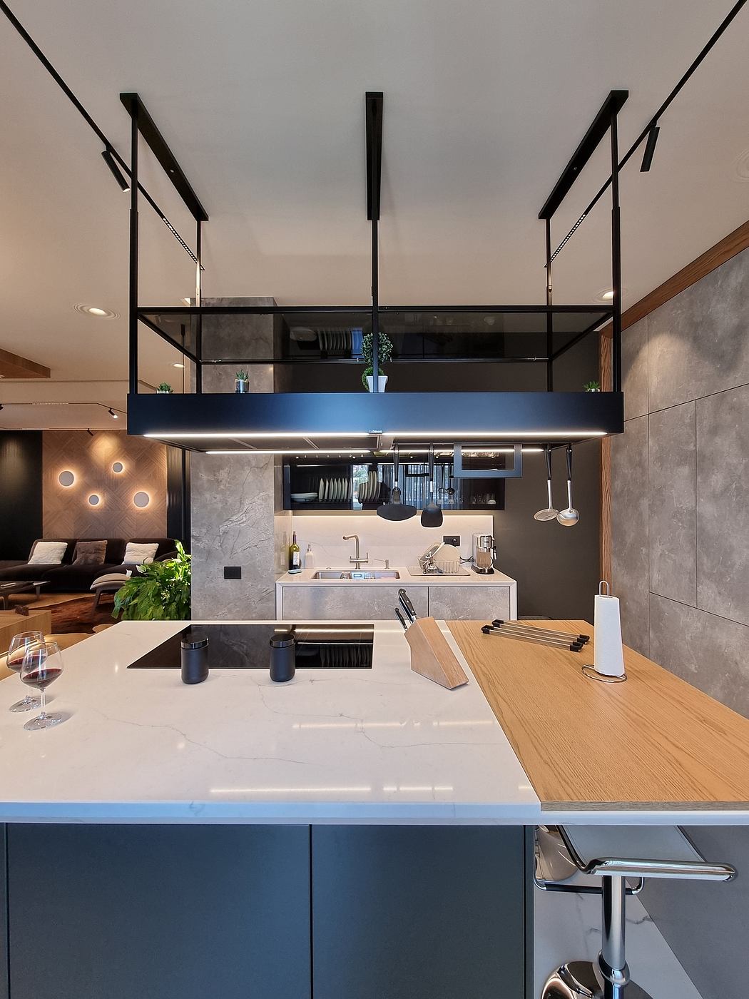 Modern, minimalist kitchen with suspended storage, wood and concrete accents, and a sleek island.