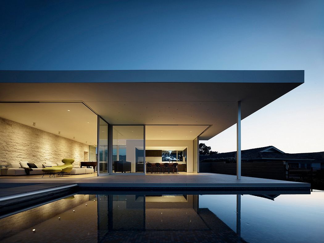 Striking architectural design with sleek lines, expansive glass, and a serene reflecting pool.