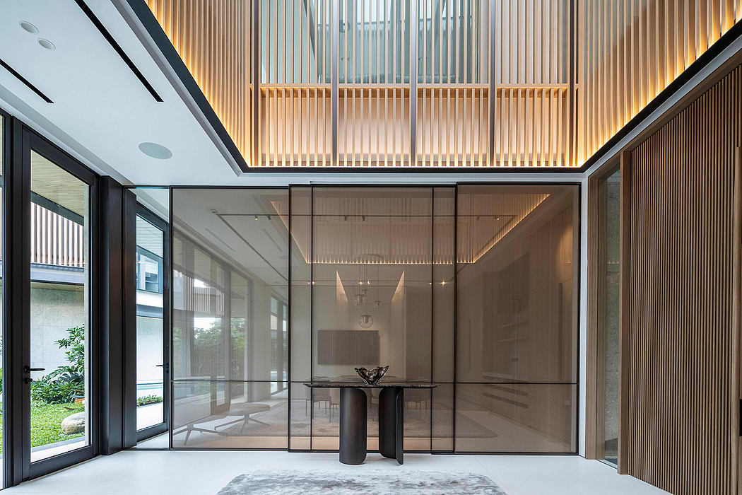 Sophisticated lobby with wooden ceiling panels, glass walls, and minimalist furnishings.
