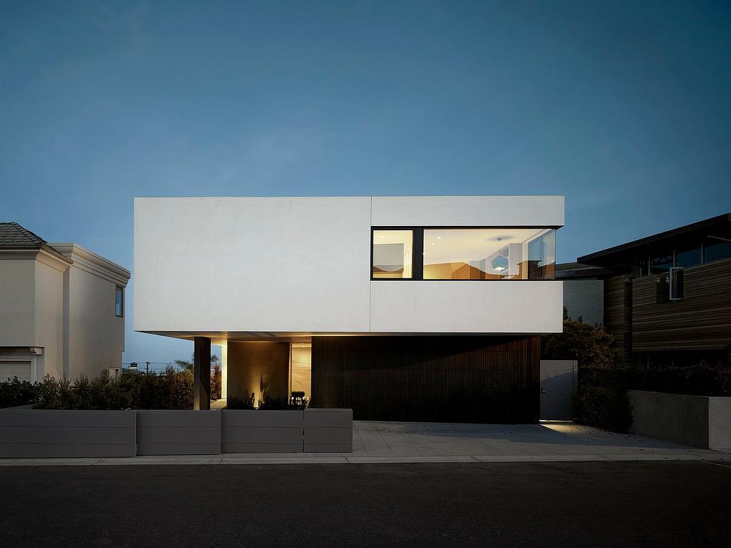 Modern minimalist residential building with clean lines, large windows, and a prominent entrance.
