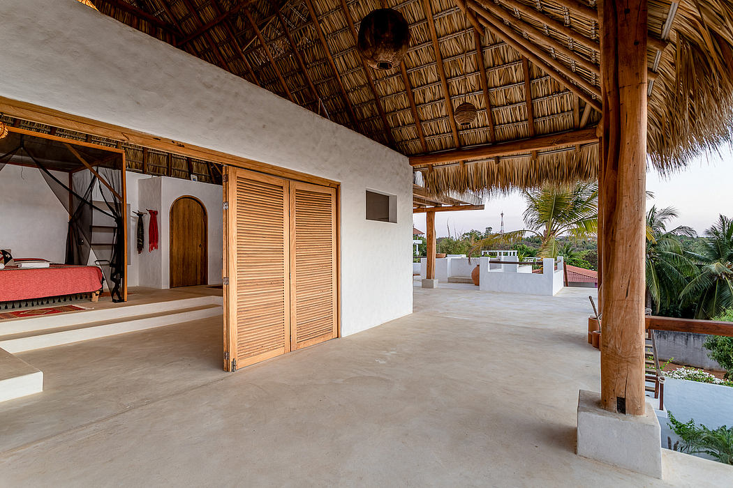 Rustic thatched roof covering an open-air tropical living space with wooden accents.