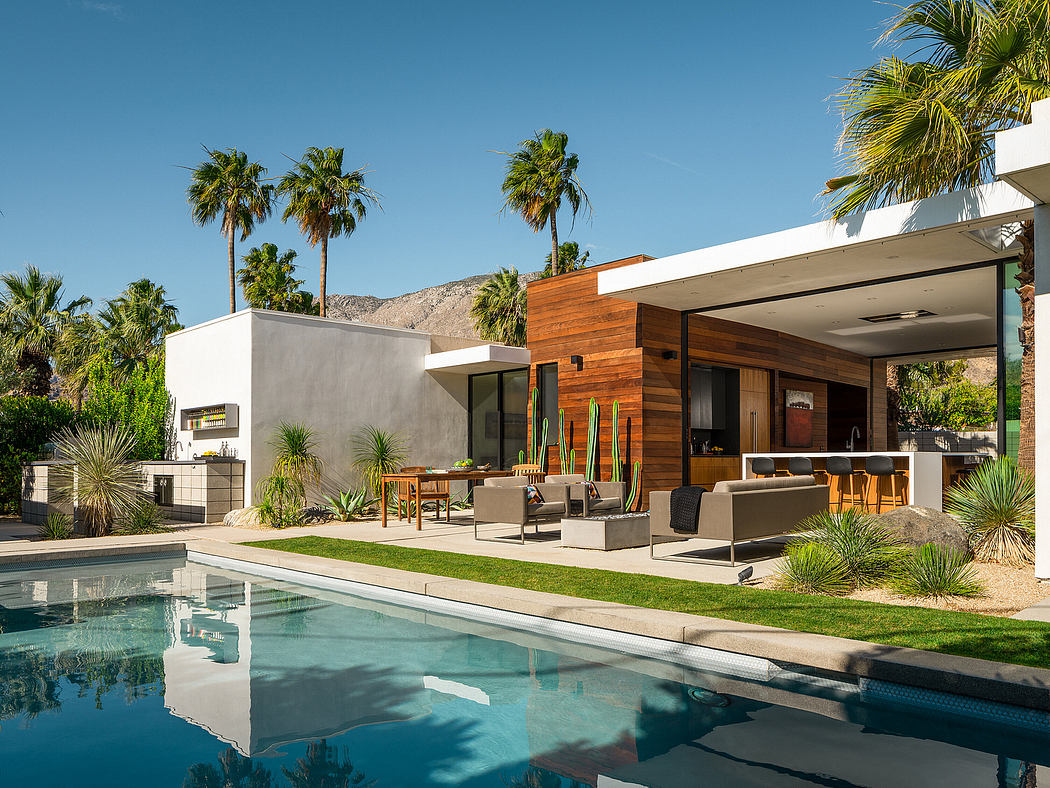 Sleek, modern desert home with wood and concrete accents, pool, and mountain backdrop.