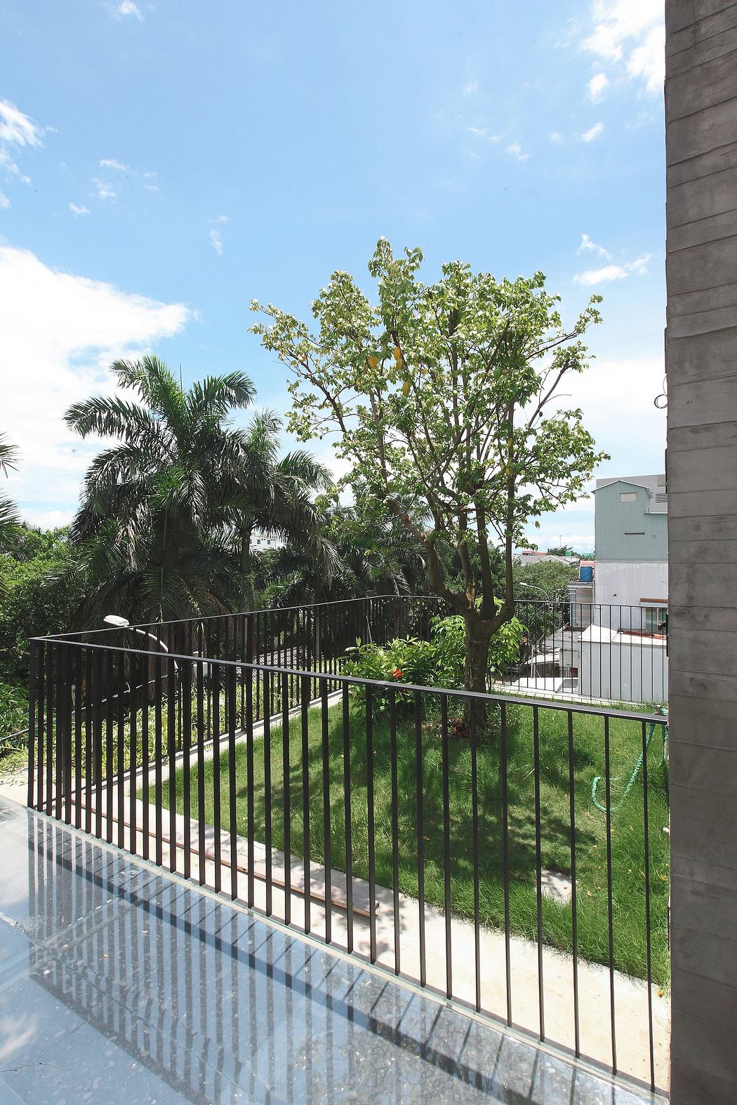 Well-designed balcony with lush greenery and a clear sky backdrop, creating a serene atmosphere.