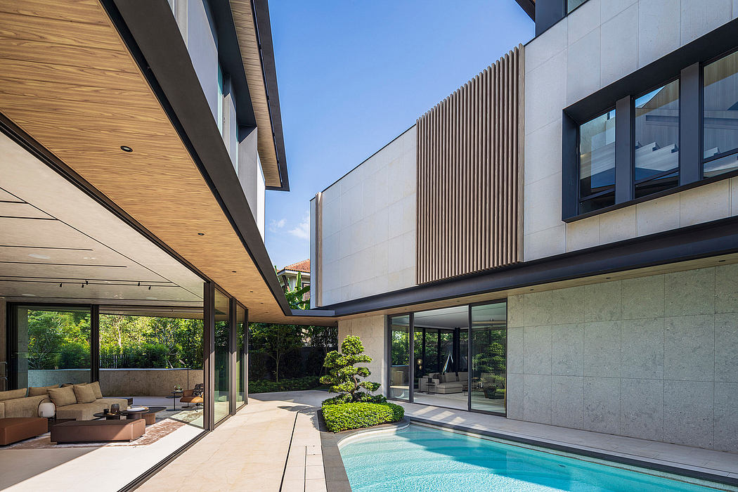 Modern, sleek architecture with wood and glass elements, an indoor pool, and lush greenery.