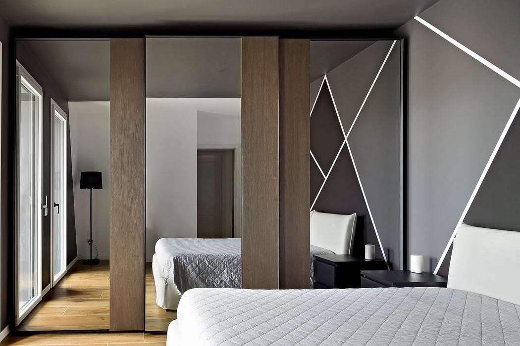 Modern bedroom with clean lines, geometric wall decor, and wood paneling features.