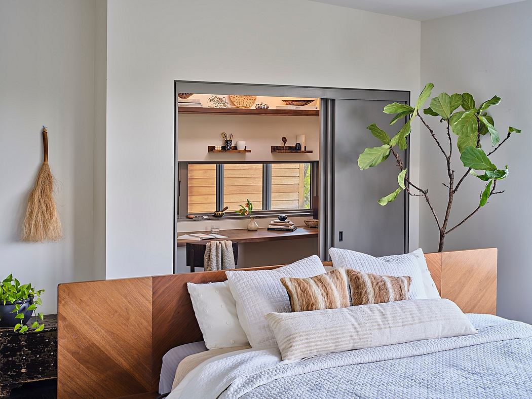 Cozy bedroom with wooden headboard, built-in shelves, and natural plants accentuating the space.