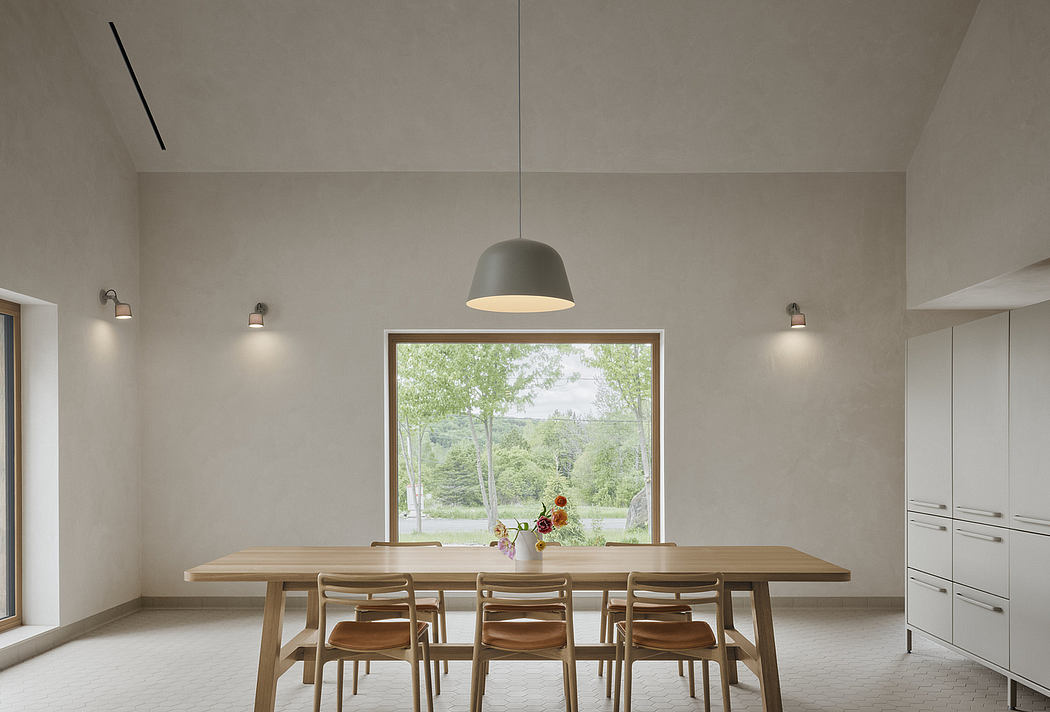 Large modern dining room with wooden table and chairs, pendant light, and expansive window.