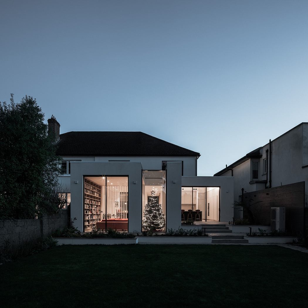 Minimalist architecture with glass walls, shelving, and a warm, inviting interior.