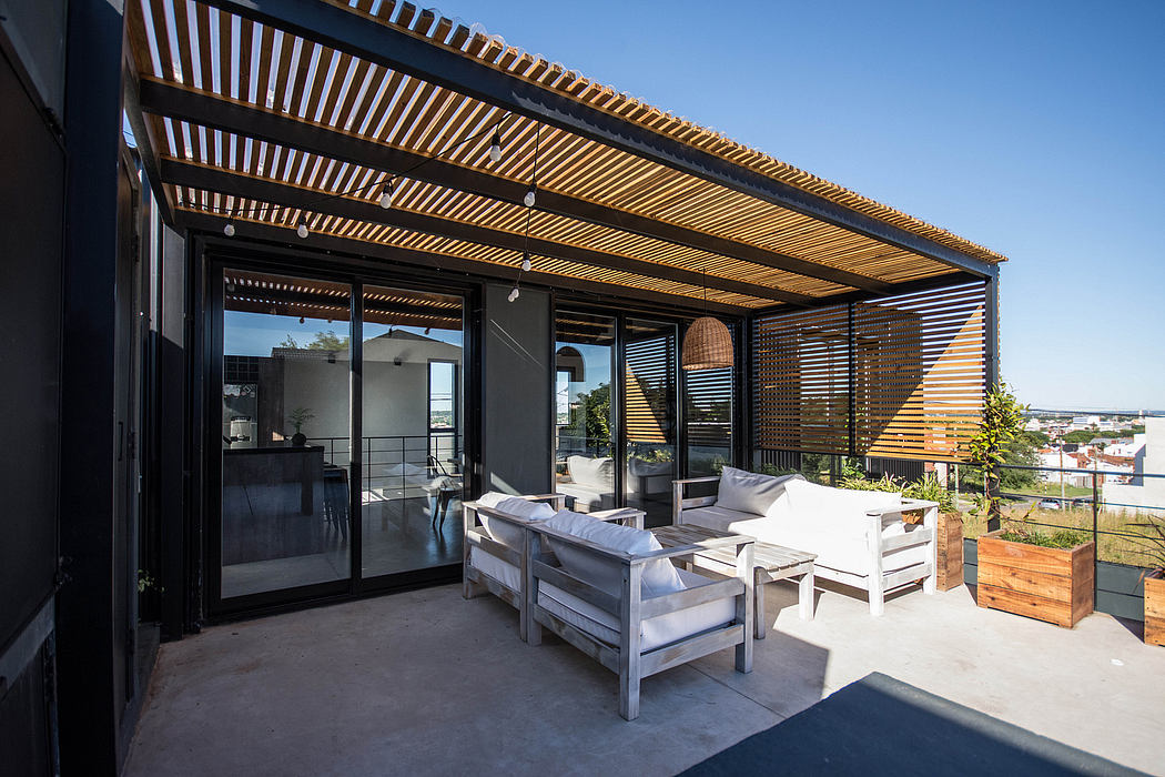 Elegant wooden pergola with modern furniture and panoramic glass windows overlooking city.