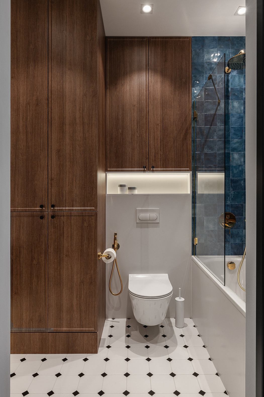 Minimalist bathroom design with dark wood cabinetry, white tile, and a glass shower enclosure.