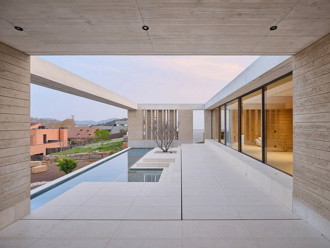 Expansive modern home with sleek concrete walls, minimalist pool, and serene mountain views.