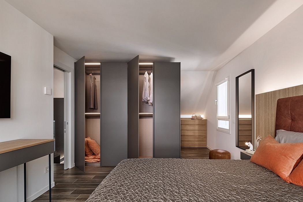 Minimalist bedroom design with built-in wardrobes, bedside table, and warm color palette.