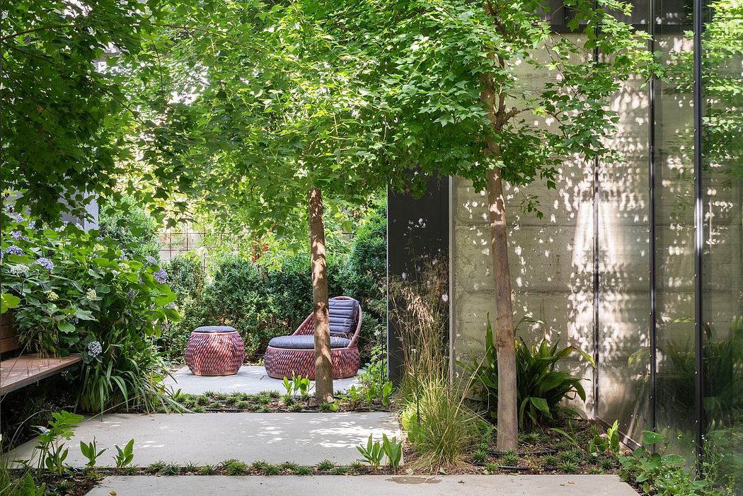 Lush garden oasis with wooden benches, potted plants, and a glass-enclosed structure.