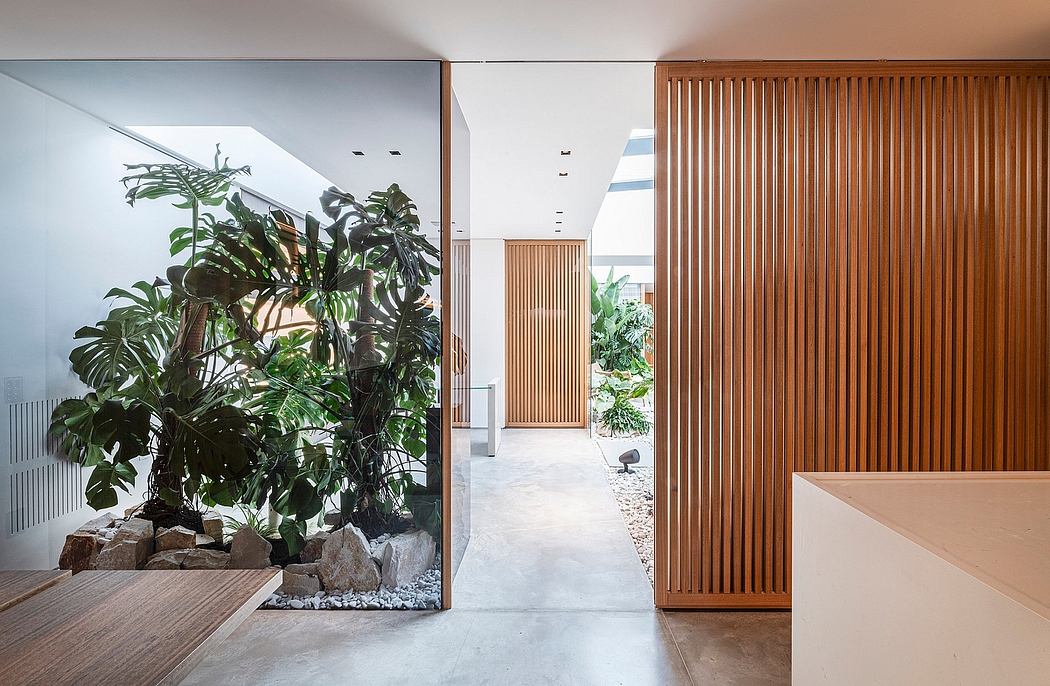 Spacious architectural interior with abundant plant life and wood accents.