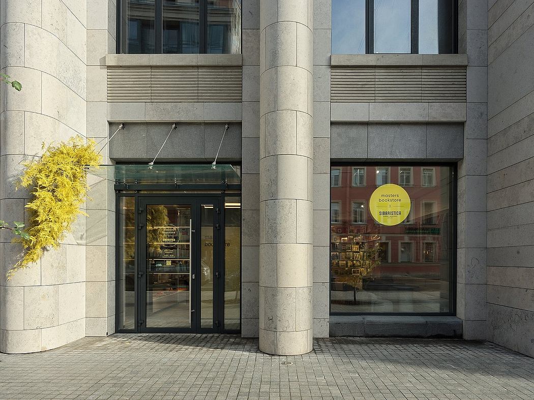 Monumental architecture with clean lines, glass entrance, and a bookstore within.