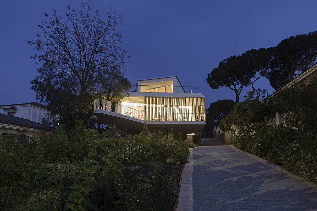 Modern architectural design with a minimalist balcony and serene garden path at night.