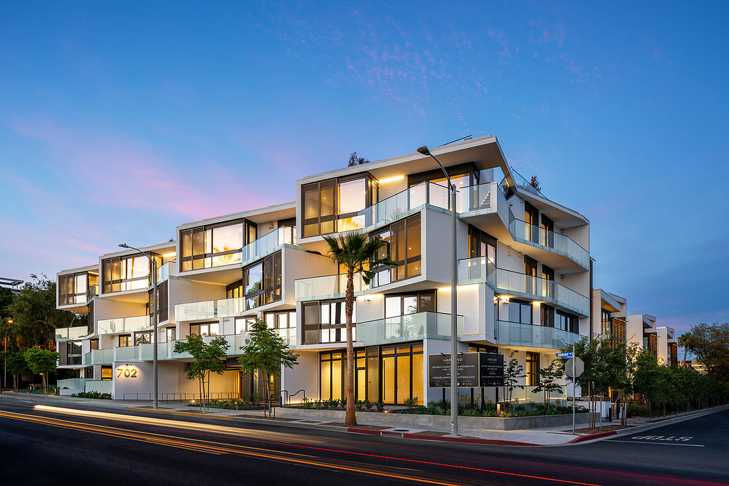 A modern multi-story apartment complex with a mix of glass and concrete elements.