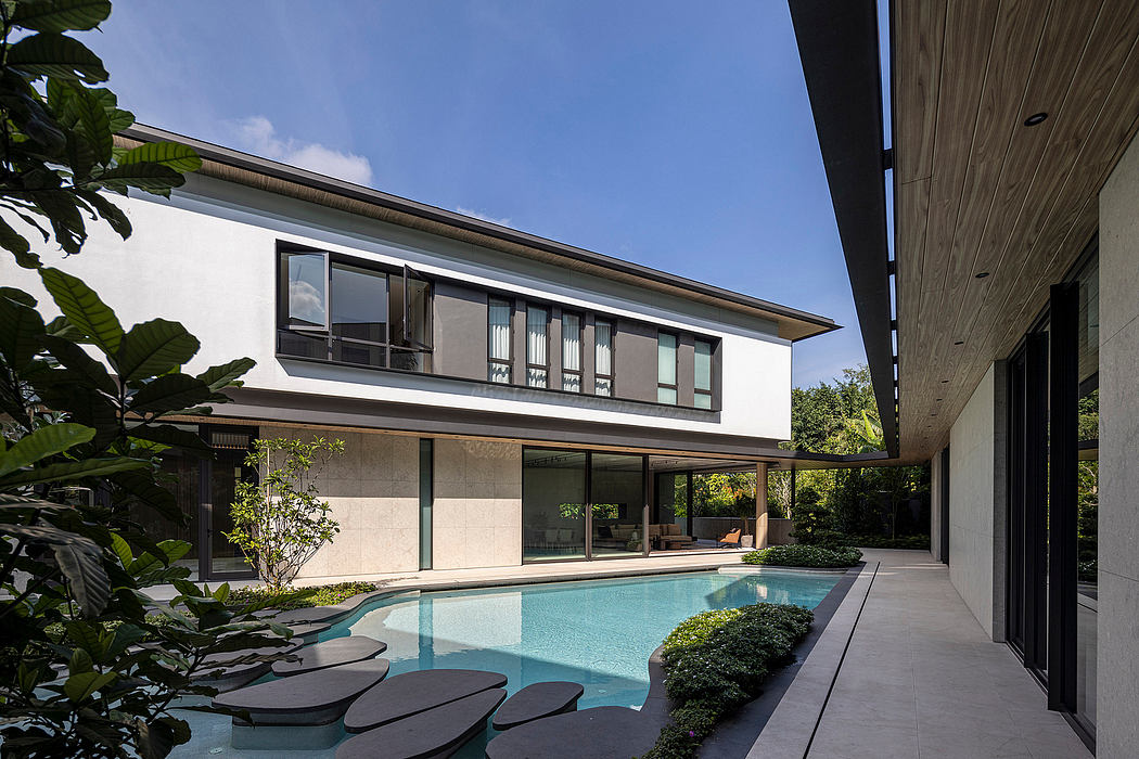 An elegant modern home with a pool, lush gardens, and a sleek architectural design.