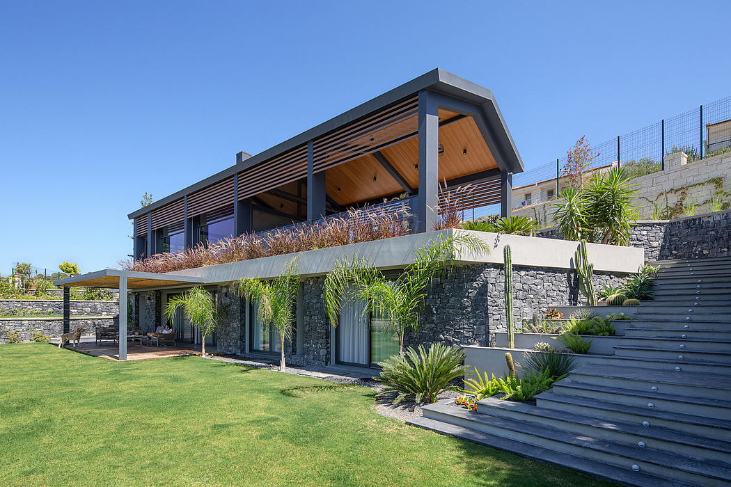 A contemporary house with a wooden and stone facade, surrounded by lush tropical greenery.