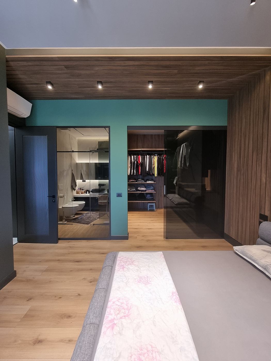 Spacious interior with wooden paneled ceiling, minimalist decor, and open closet design.