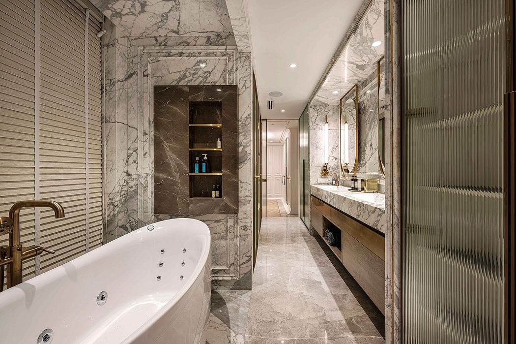 Luxurious marble bathroom with freestanding tub, built-in shelving, and vanity.
