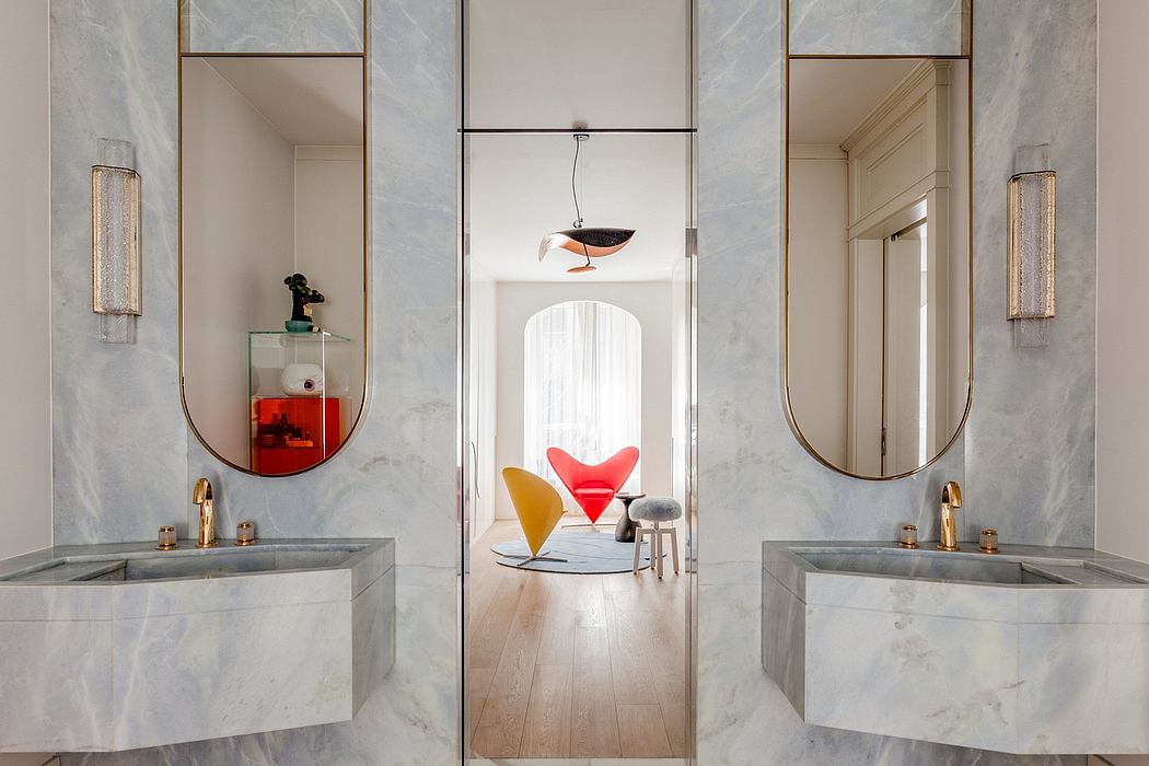 Lavish marble vanities, geometric mirrors, and a bold, sculptural pendant light.