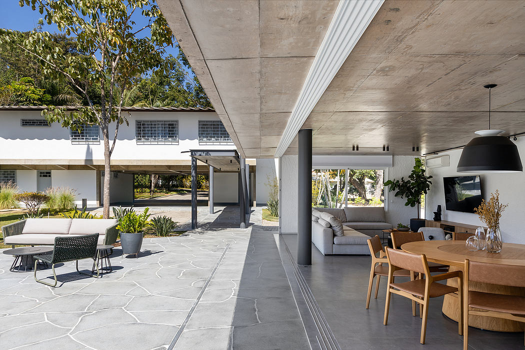 Elegant concrete architecture featuring an open-plan interior with natural wood furnishings.