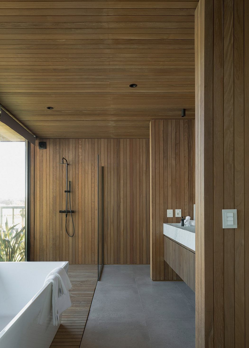 Minimalist wooden bathroom with sleek tile flooring and modern fixtures.