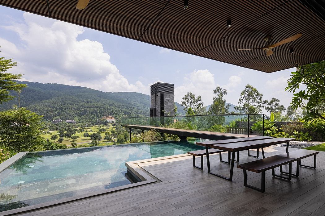 Expansive glass walls frame lush greenery, infinity pool, and modern architectural elements.