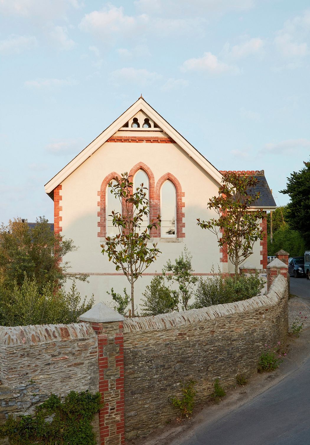 A charming stone and brick building with arched windows and a decorative roof structure.