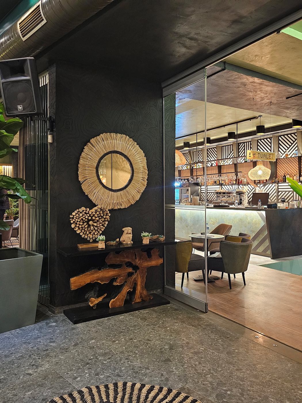 Modern, cozy cafe design with abstract wall decor, wooden beams, and stylish furnishings.