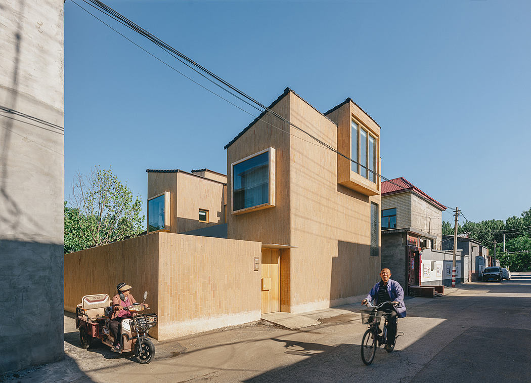 Modern, multi-level residential buildings with wooden facades, large windows, and bicyclists on the street.