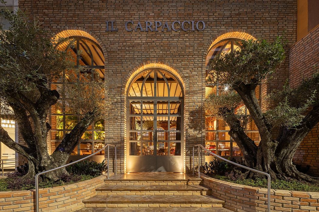 Brick arched entrance framing a warm, lighted interior of Il Carpaccio restaurant.