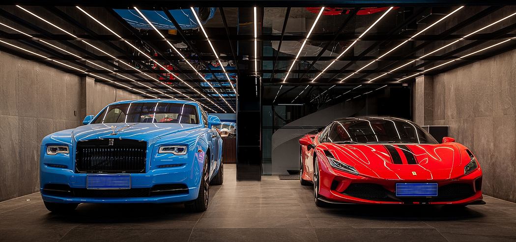 Sleek, modern showroom showcases luxury vehicles against a backdrop of dramatic lighting and steel beams.