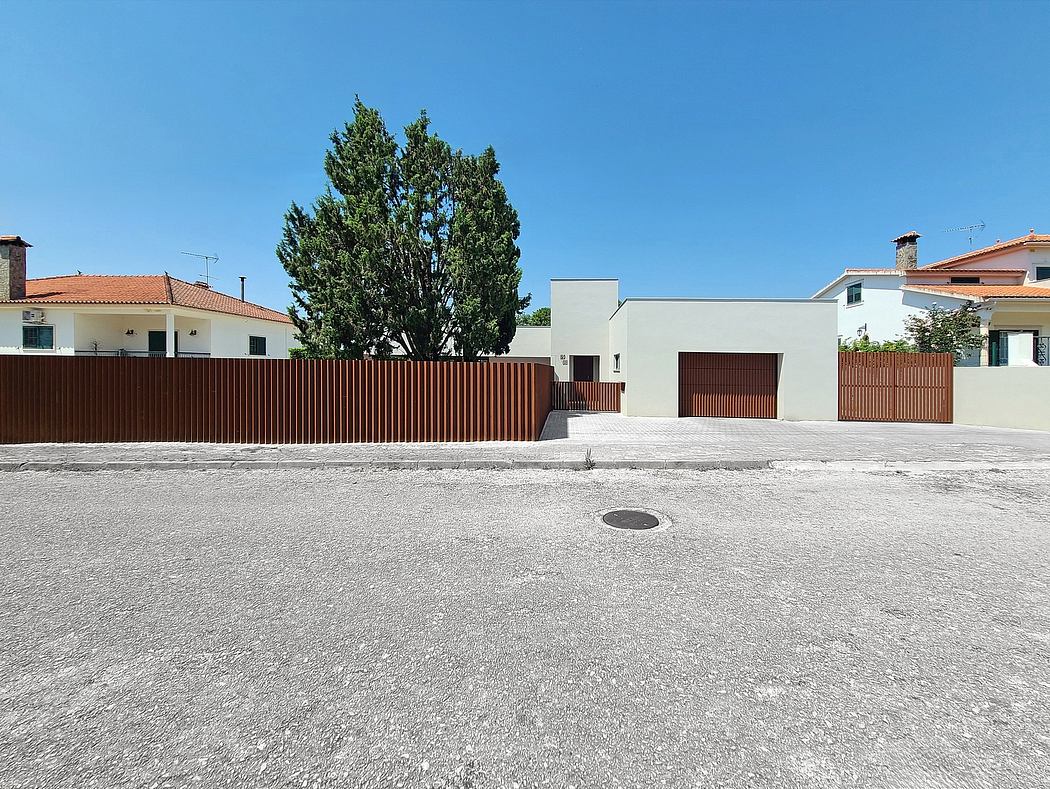 Residential buildings with contemporary architectural features and a tall tree.