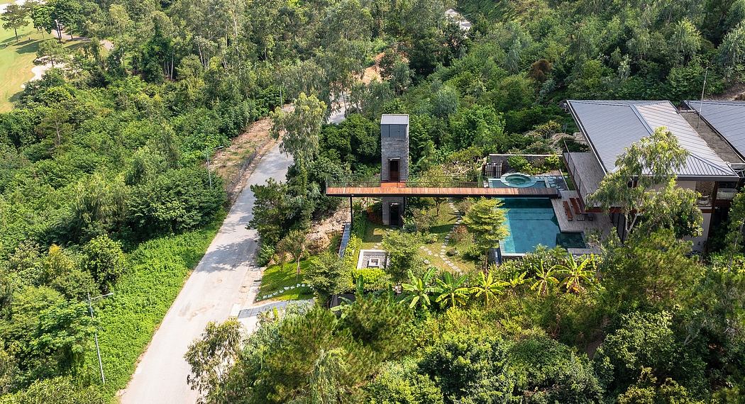 A modern, elevated home nestled in lush green foliage with a swimming pool and walking path.