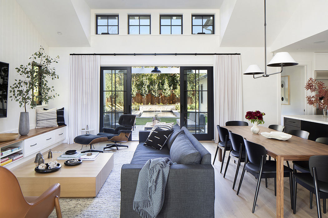 Spacious living room with ample natural light, open floor plan, and blend of modern and natural elements.