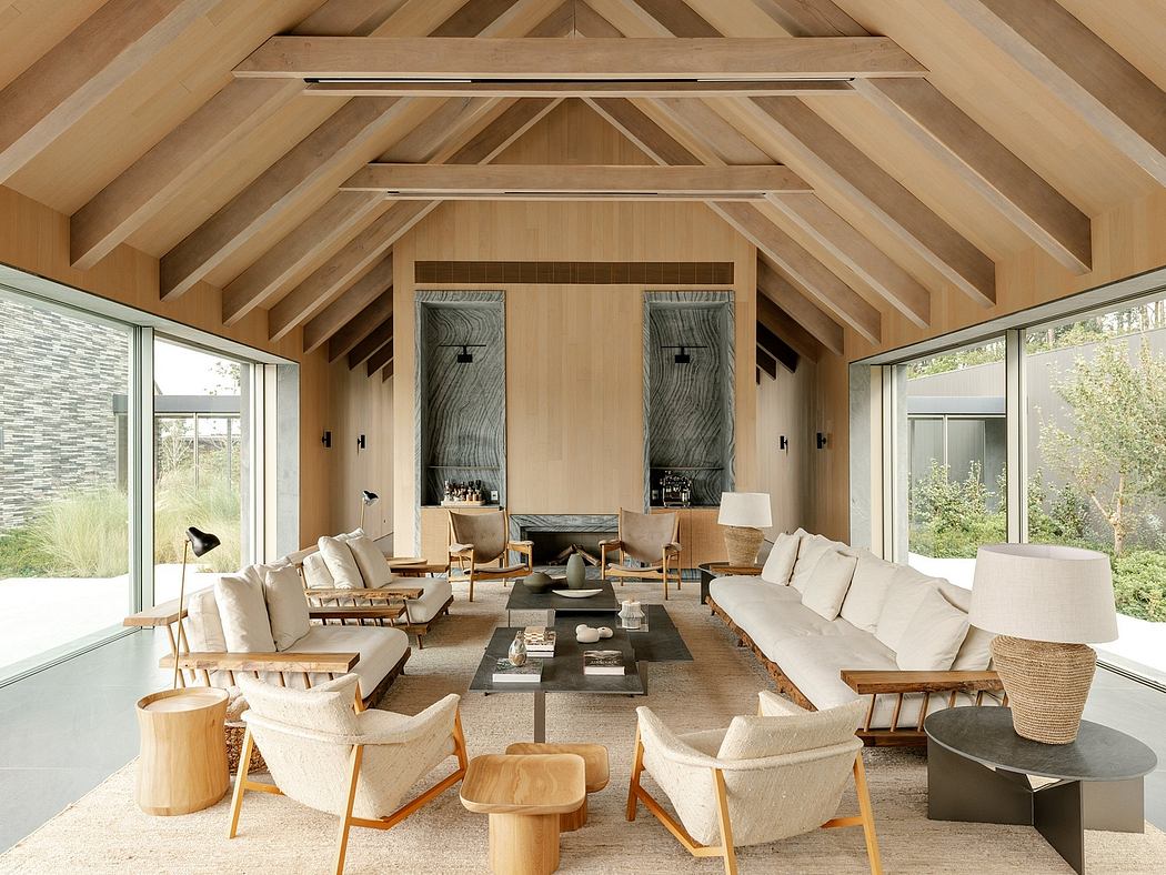 Spacious living room with high, wooden-beamed ceilings and large windows offering a scenic view.