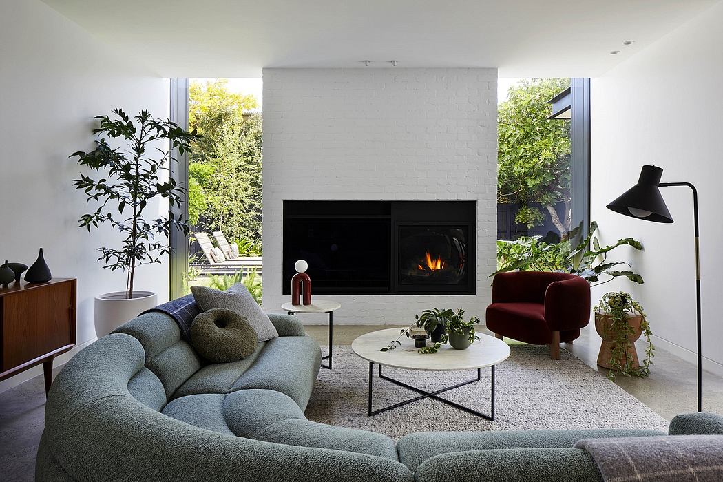 Modern, minimalist living room with sleek fireplace, plush seating, and lush greenery.