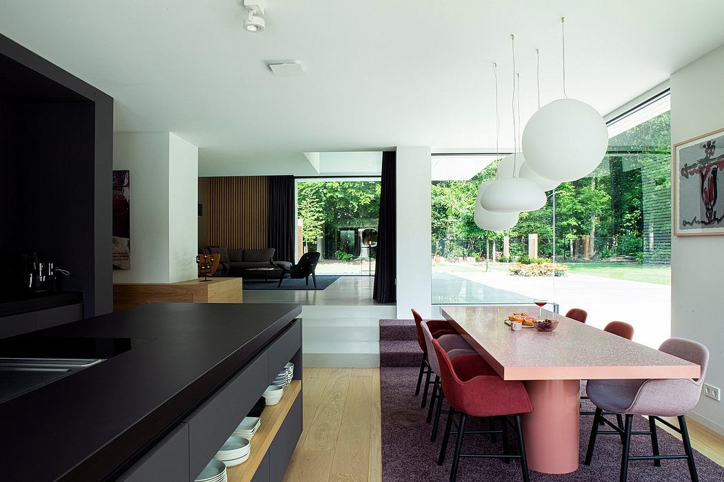 Minimalist open-plan interior design with sleek kitchen, dining area, and living room.