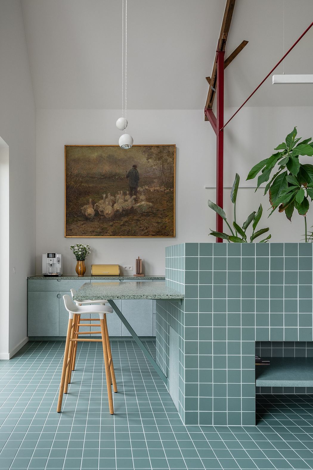 Minimalist kitchen with green tile accent wall and modern wooden barstool.