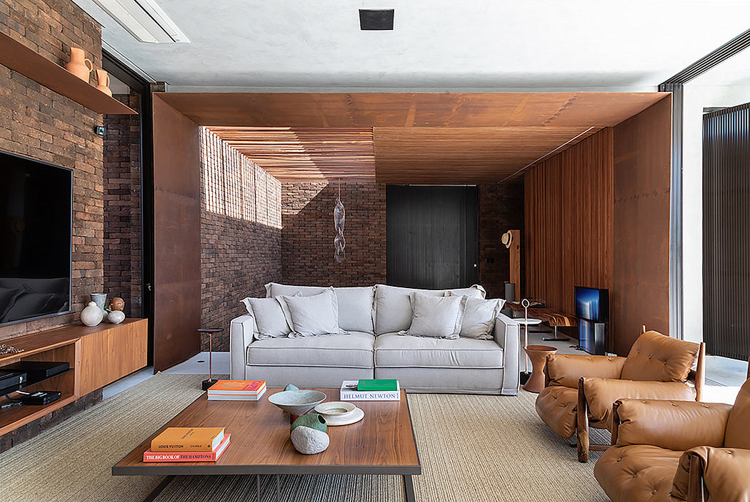 Cozy modern living room with brick walls, wooden ceiling, and comfortable seating.