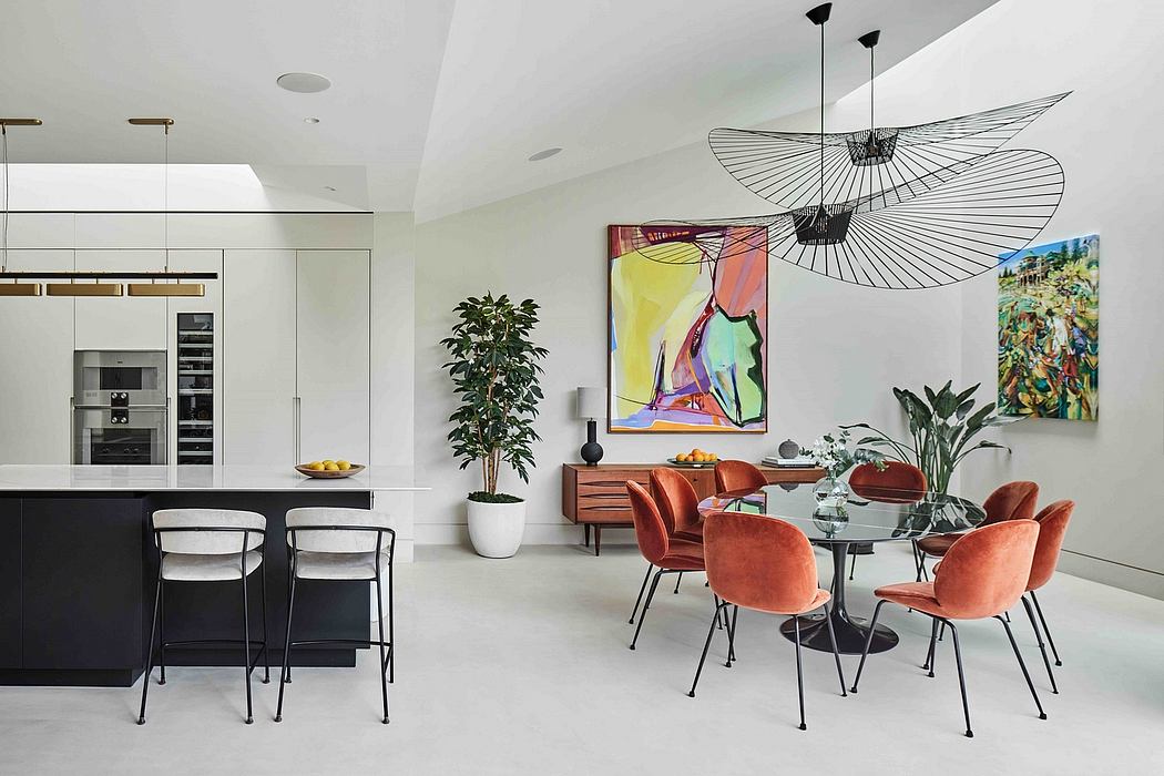 Stylish open-concept kitchen and dining area with modern furniture and artwork.