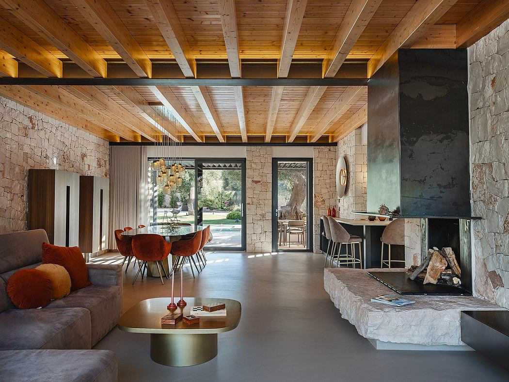 A cozy, rustic living space with exposed wooden beams, stone walls, and a modern fireplace.