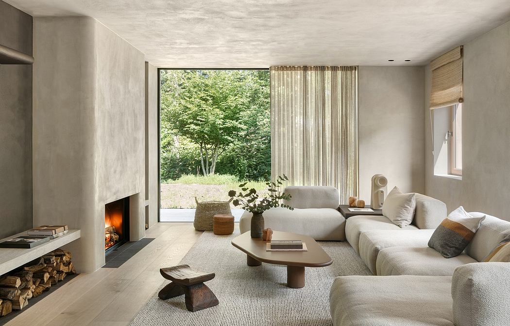 Minimalist living room with large window, cozy fireplace, and natural textures.