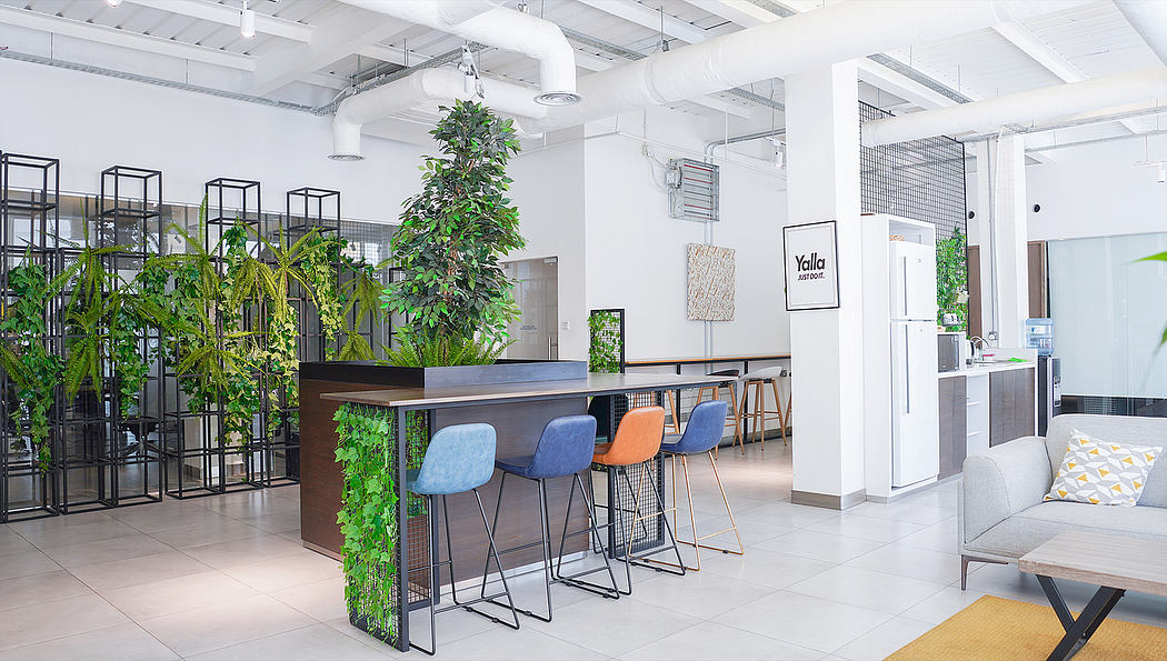 Stylish and minimalist office space with lush greenery, modern furniture, and industrial accents.