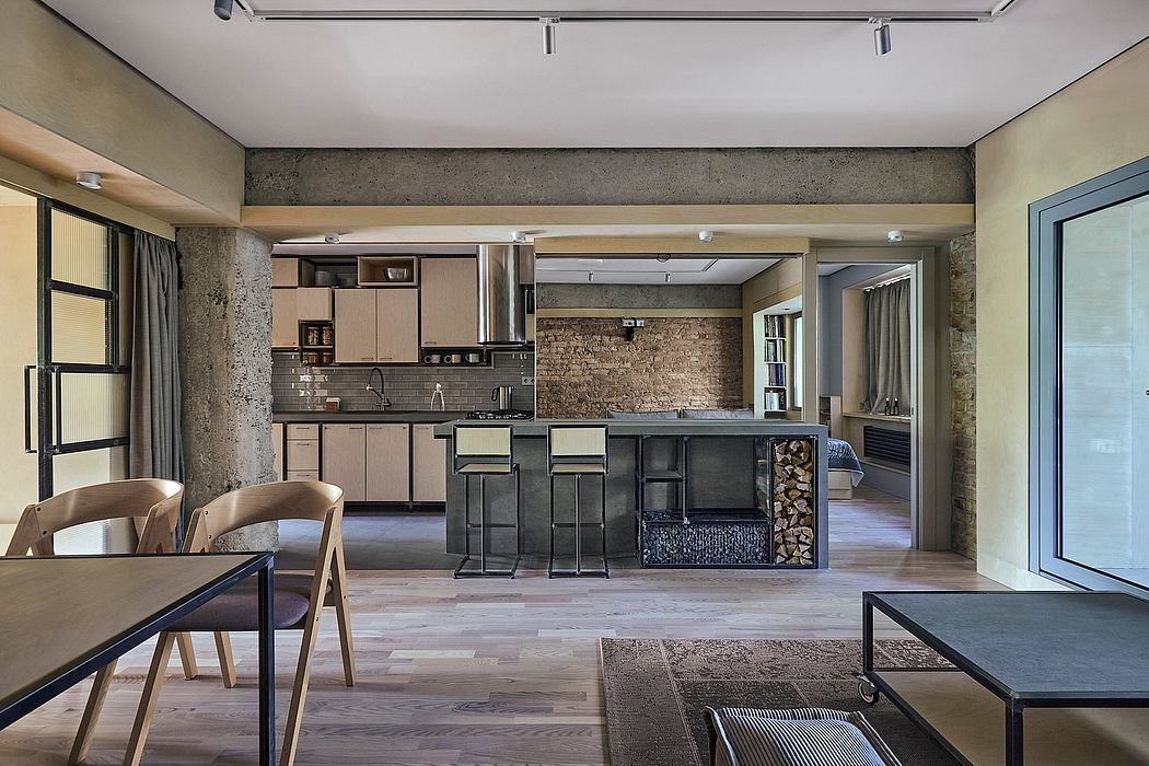 Modern loft kitchen with exposed brick walls, wood floors, and minimal furnishings.