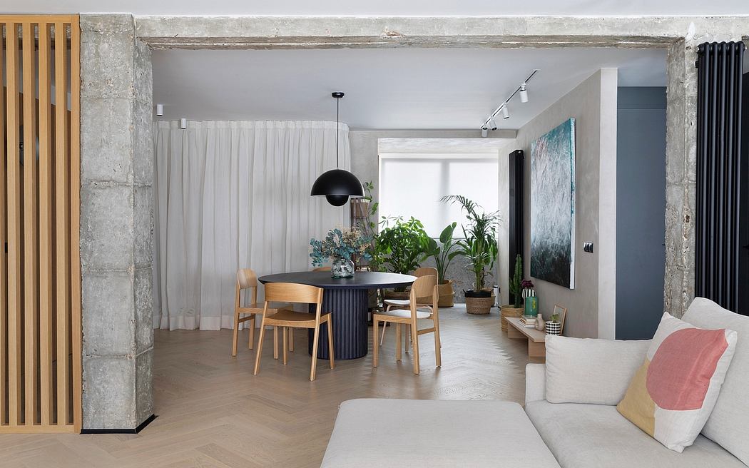Modern, minimalist living room with wood furniture, plants, and neutral color palette.