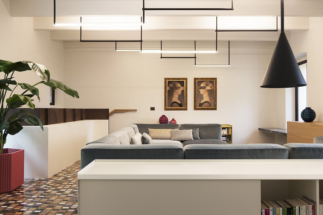 Sleek, modern interior featuring geometric lighting, framed artwork, and a cozy sectional sofa.